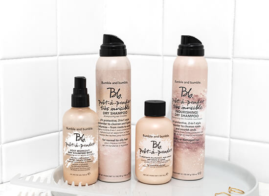 Pret-A-Powder dry shampoos on counter top in white bathroom